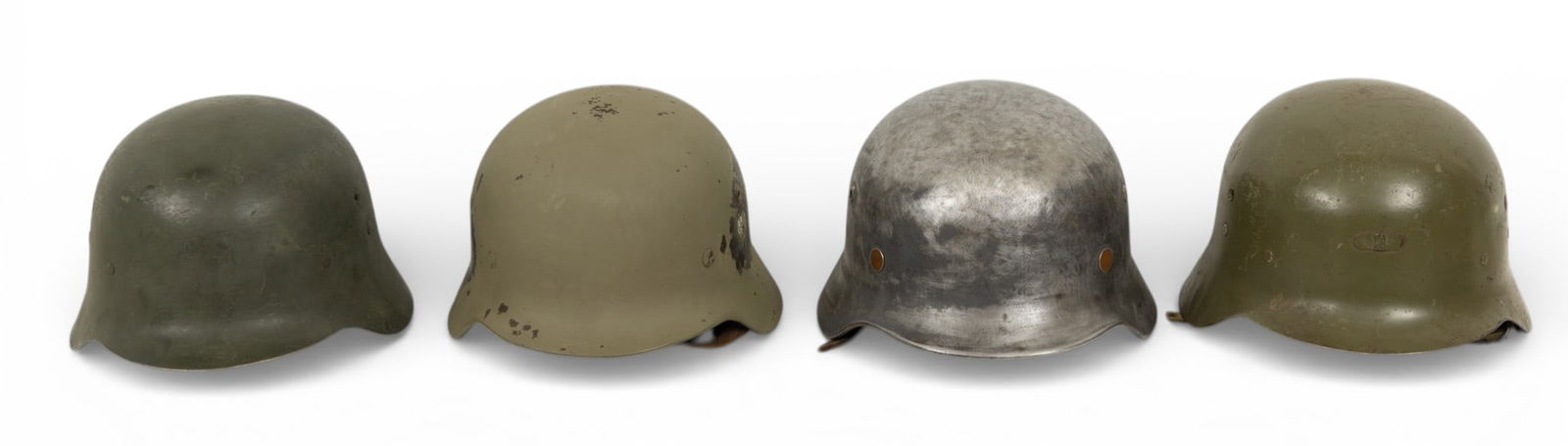 German & Spanish M1942 & M35 Steel Helmets WWII, 4 PCS: German & Spanish M1942 & M35 Steel Helmets WWII, 4 PCS Each having a leather pad liner. Two with leather straps and two with canvas straps. One marked Q64, 5838. Two M1942 modelo Z helmets with u