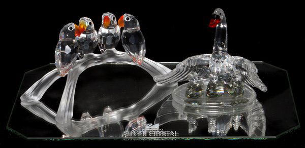 SWAROVSKI CRYSTAL PARROTS & SWAN WITH 3 CYGNETS: SWAROVSKI CRYSTAL PARROTS AND SWAN WITH 3 CYGNETS, 2 PCS., H 2 1/4" - 2 1/2", L 4":includes four parrots perched on a branch, orange and yellow beaks, black eyes; mother swan with red and black bill,