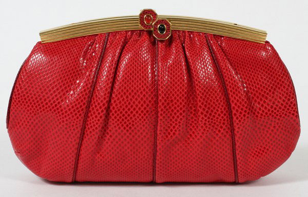 JUDITH LEIBER RED LIZARDSKIN EVENING BAG, W 9": JUDITH LEIBER RED LIZARDSKIN EVENING BAG, W 9":Gold tone frame set with two cabochons, opening to red silk lining and gold tone shoulder strap. Stamped: Judith Leiber. Measures W.9 3/4" x 5 1/2" (25"