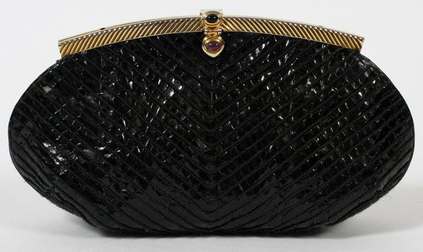 JUDITH LEIBER BLACK LIZARDSKIN EVENING BAG: JUDITH LEIBER BLACK LIZARDSKIN EVENING BAG, W 9 1/4":Gold tone frame set with two cabochons, opening to black silk lining and gold tone shoulder strap. Stamped: Judith Leiber. Measures W.9 1/4" x 5" (