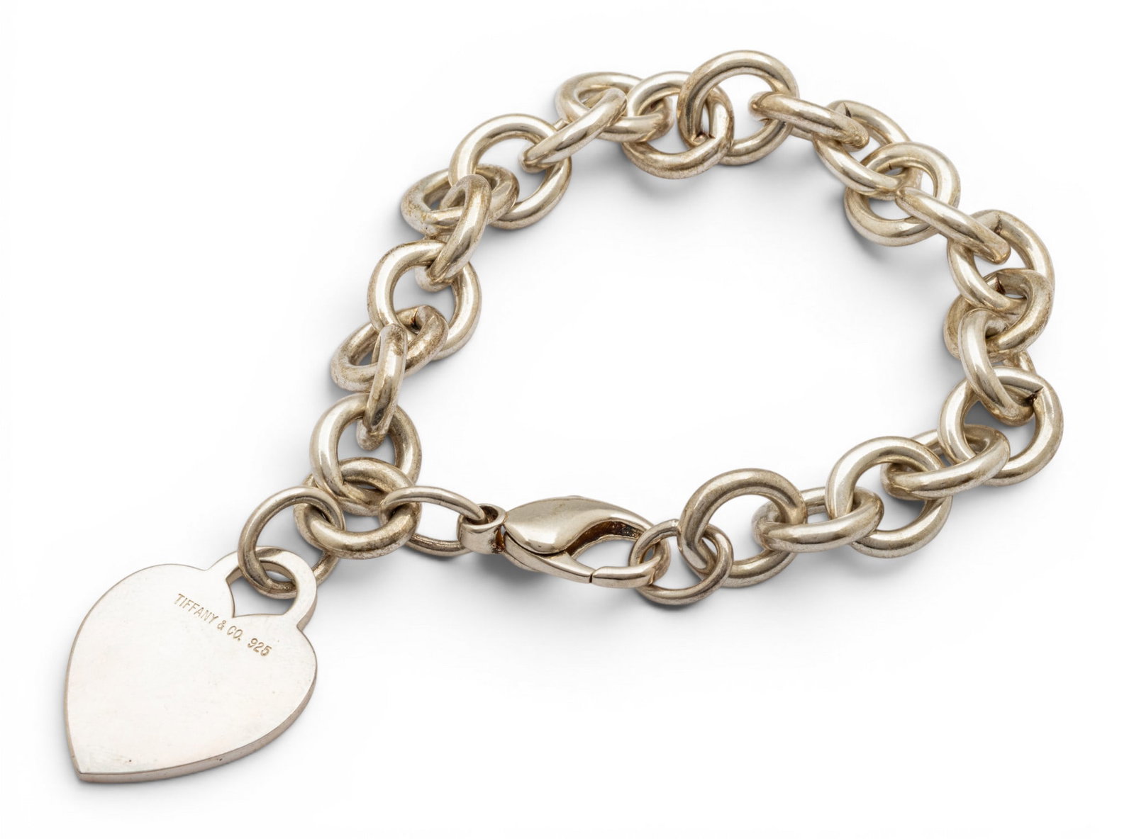 Tiffany & Co. (New York) Sterling Silver Heart Bracelet L 7": Tiffany & Co. (New York) Sterling Silver Heart Bracelet L 7" Approx total 1.2 t oz. Marked Tiffany & Co / 925. Includes blue Tiffany & Co. box. Provenance: From the Estate of Frank Isbey