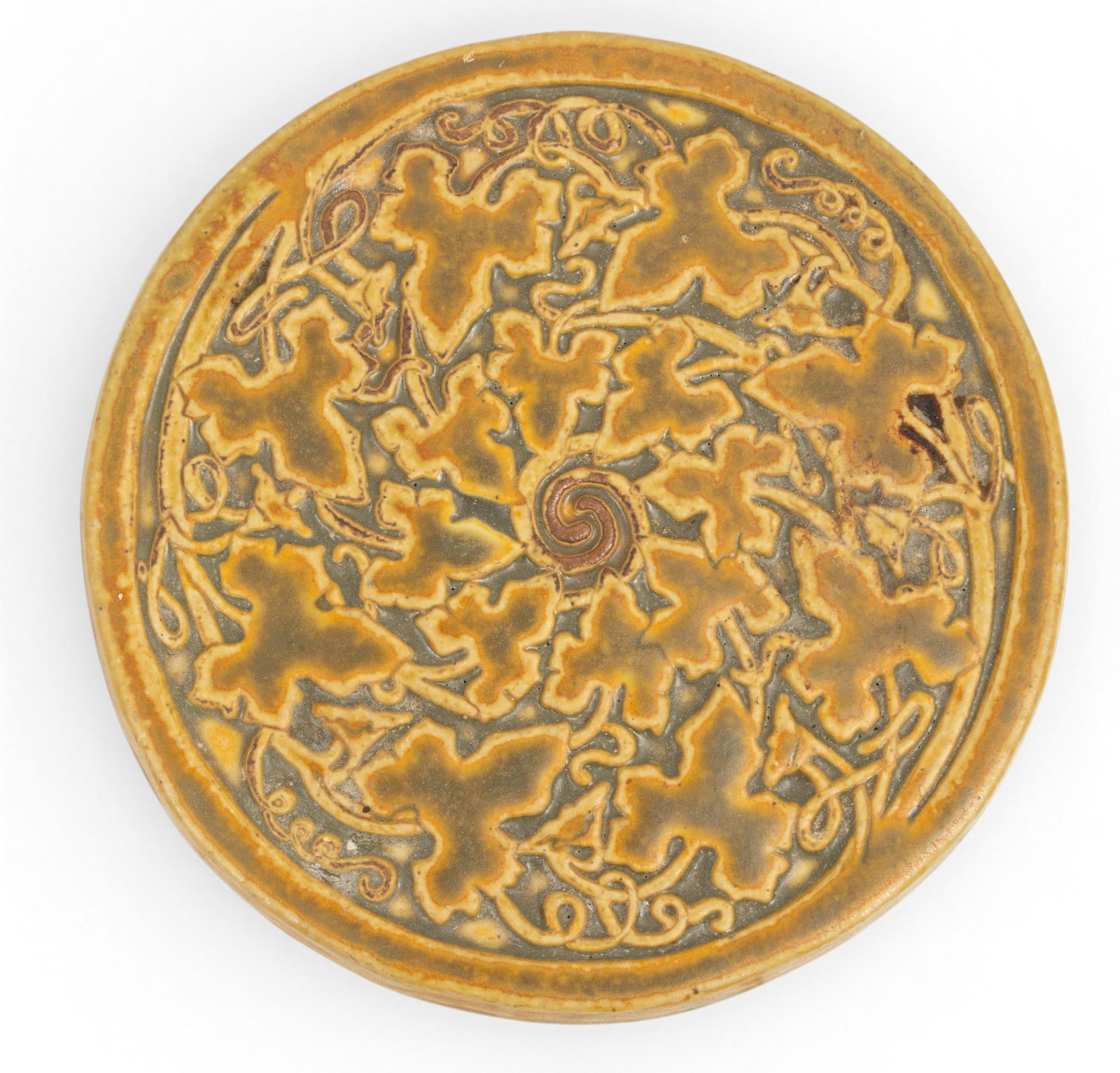 Pewabic Pottery Tile, Dia 7": Pewabic Pottery Tile, Dia 7" With impressed Pewabic trademark, 1991. Motif of maple leaves. Provenance: Property from the Collection of Marianne Endicott, Grosse Pointe Shores, MI Dimensions: Dia 7"