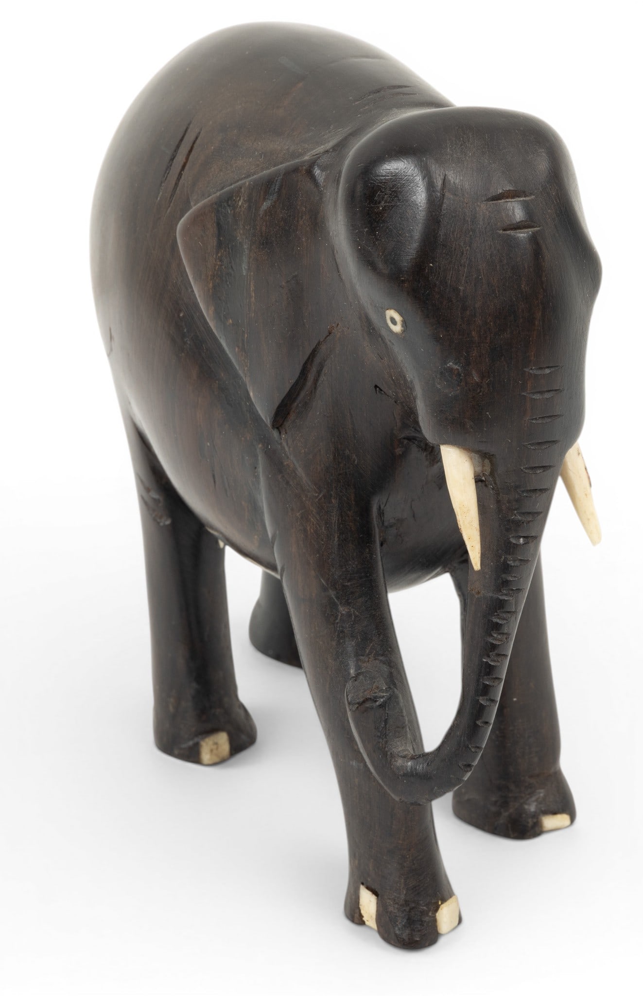 Teakwood Hand Carved Elephant from Tanganyika H 6" L 6": Teakwood Hand Carved Elephant from Tanganyika H 6" L 6" Heavy solid teakwood. Ivory tusks and toes. Overall H 6", L 6". Brought from Africa by Simon Denuyl. Provenance: Property from the Collection of