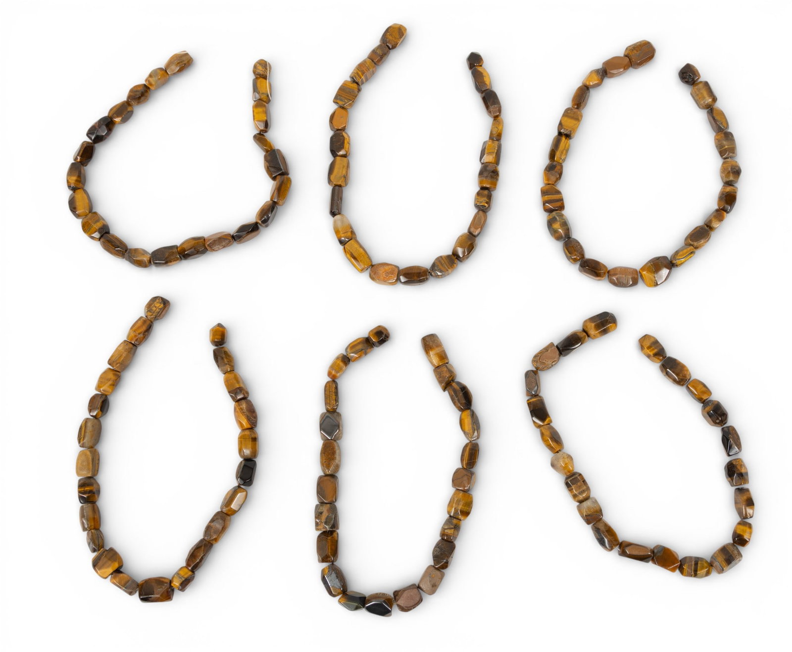Six African Tiger's Eye Trade Bead Strands 6 PCS: Six African Tiger's Eye Trade Bead Strands 6 PCS Six strings of African Tiger's Eye beads, each appx. 16" long. Appx. volumetric dimensions for shipping 4 x 9 x 2 in. Provenance: Property from