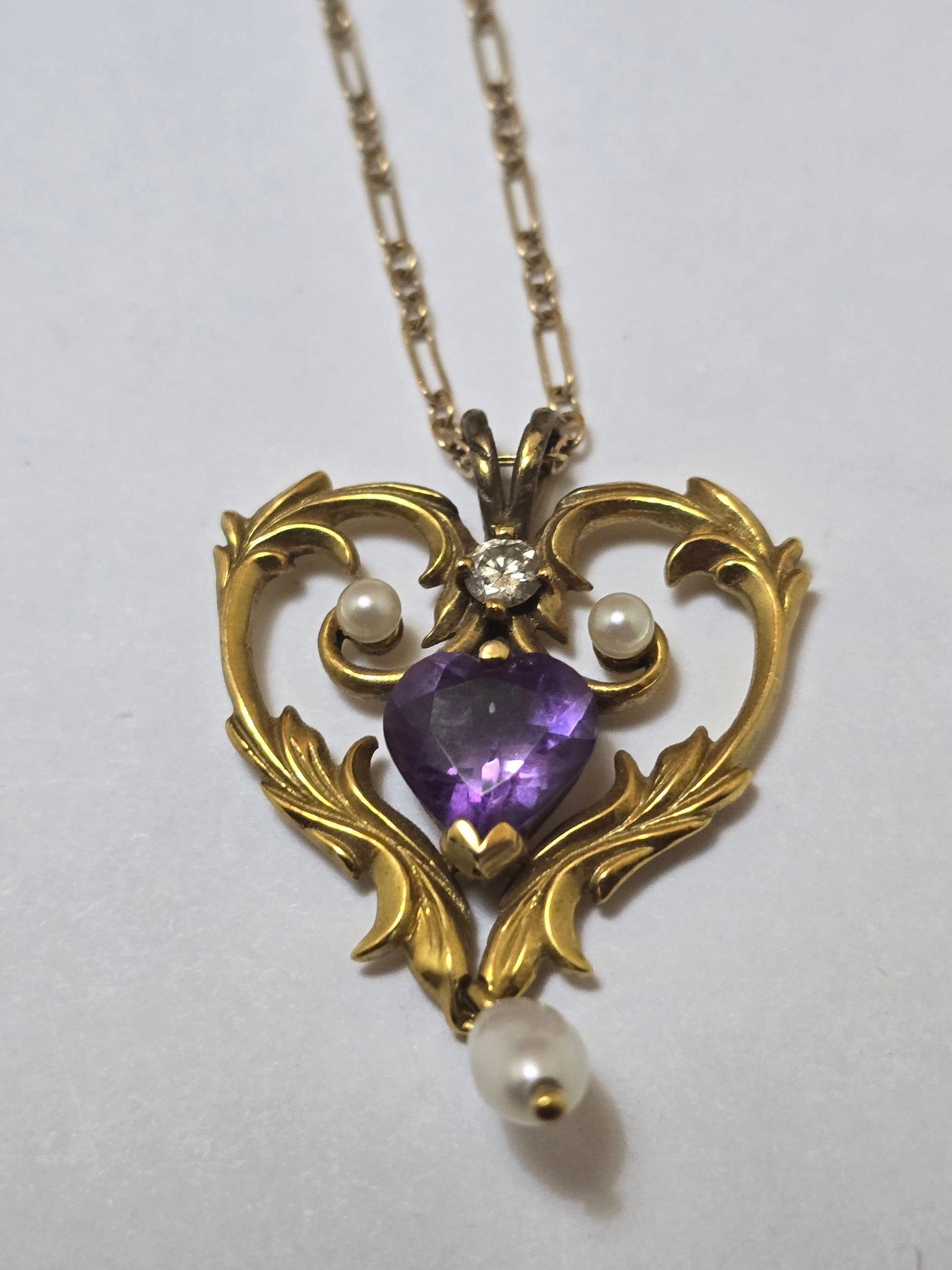 14kt Yellow Gold Lavaliere, with Pendant Impressed 585, Heart Shaped Amethyst, 3 Seed Pearls and: 14kt Yellow Gold Lavaliere, with Pendant Impressed 585, Heart Shaped Amethyst, 3 Seed Pearls and Diamond Enhancement. L 18" 6 g 1 PC Pendant impressed FM87. Provenance: Property from the Collect