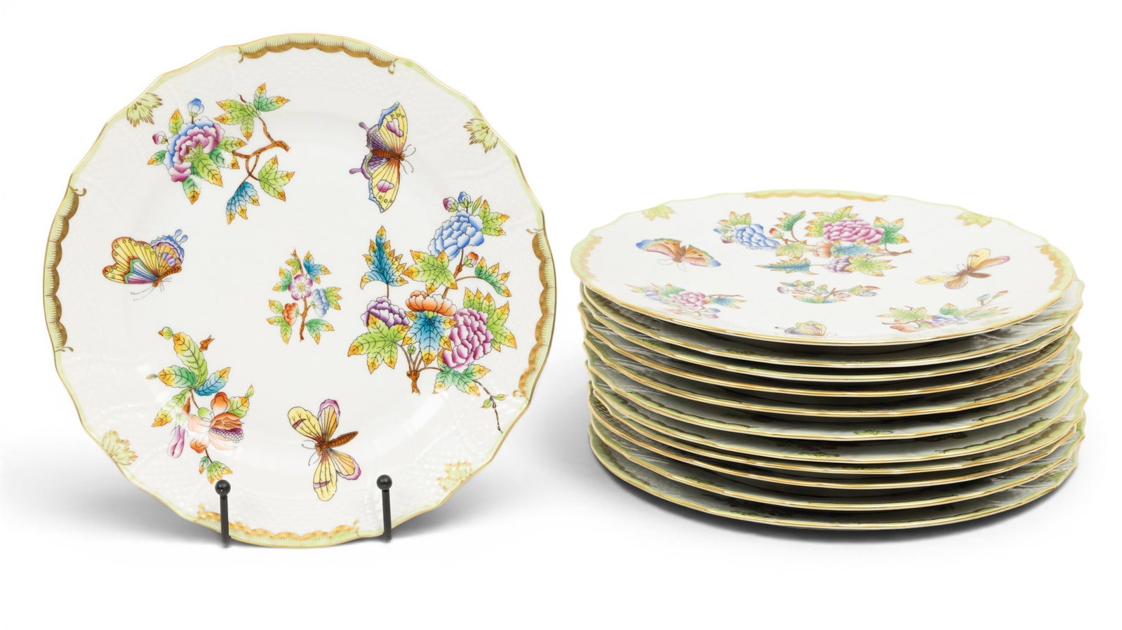 Herend (Hungary) Porcelain Plates 'Queen Victoria', Dia. 10" 12 PCS: Herend (Hungary) Porcelain Plates 'Queen Victoria', Dia. 10" 12 PCS Hand painted with gilt and green border, decorated with foliates and butterflies. Provenance: From the Estate of Frank Isbey, b