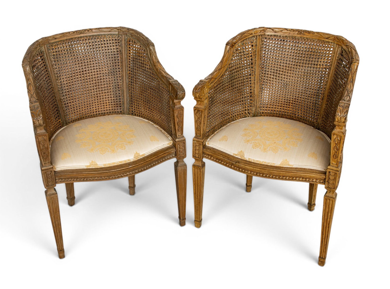 In the Manner of Georges Jacob (French, 1739-1814) Louis XVI Hand Carved Walnut Fauteuil De Bureau,: In the Manner of Georges Jacob (French, 1739-1814) Louis XVI Hand Carved Walnut Fauteuil De Bureau, Ca. 18th C., H 32" W 22" Depth 20" 1 PAIR With double cane panels. Having a silk upholstered inset s