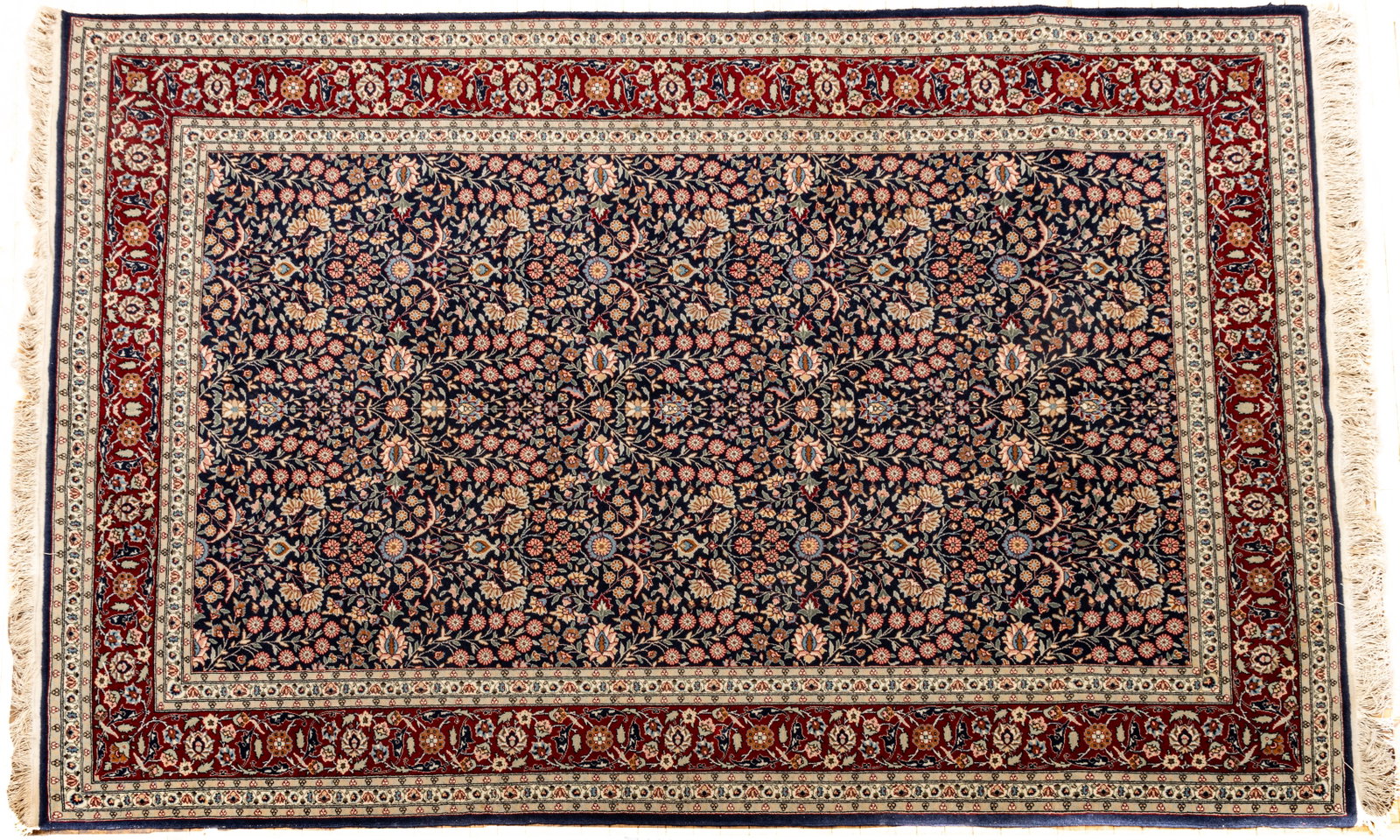 Persian Isfahan Handwoven Wool Rug, Ca. 1980, W 6' L 9': Persian Isfahan Handwoven Wool Rug, Ca. 1980, W 6' L 9' Navy central field with dense scrolling floral designs. Red outer border also with scrolling floral patterns. Tightly woven. Provenance: Propert