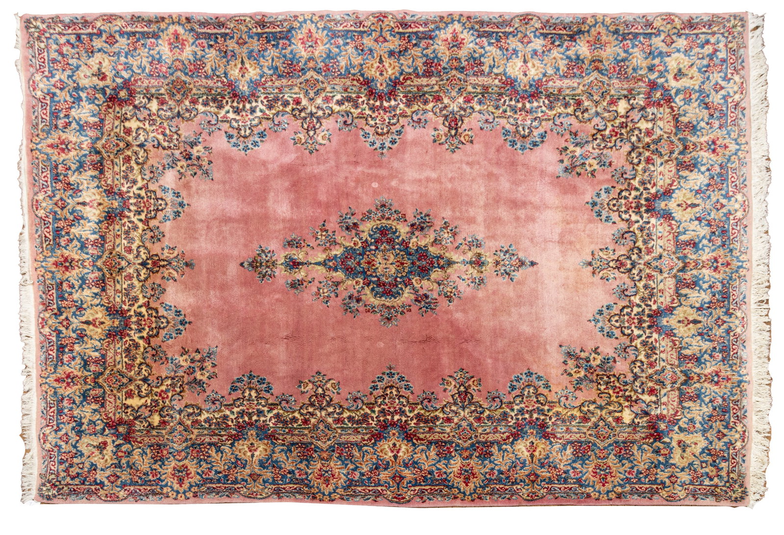 Persian Kerman Handwoven Wool Rug, Ca. 1970s, W 7' 6" L 10': Persian Kerman Handwoven Wool Rug, Ca. 1970s, W 7' 6" L 10' Pink ground, central medallion, wide floral border. Provenance: Property from a Private Collector, Grosse Pointe Shores, MI Dimensions