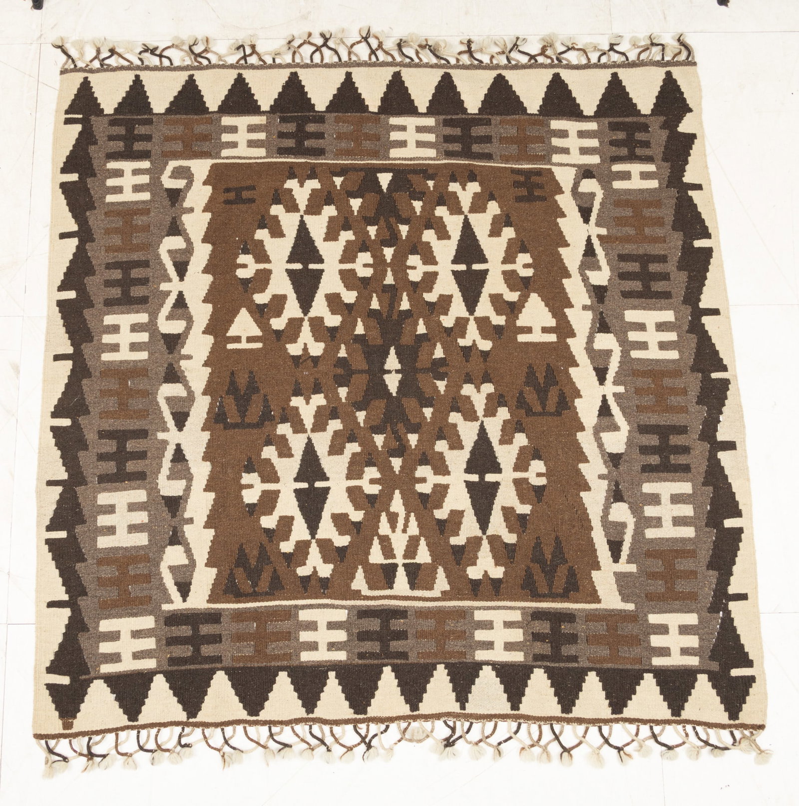 Turkish Hand Flat Woven Serapi Carpet 1970, W 4.5' L 4.7' 1 PC: Turkish Hand Flat Woven Serapi Carpet 1970, W 4.5' L 4.7' 1 PC Brown, black, beige. Decorative fringe. Similar to a Navajo flat woven. Dimensions: W 4.5' L 4.7' 1 PC