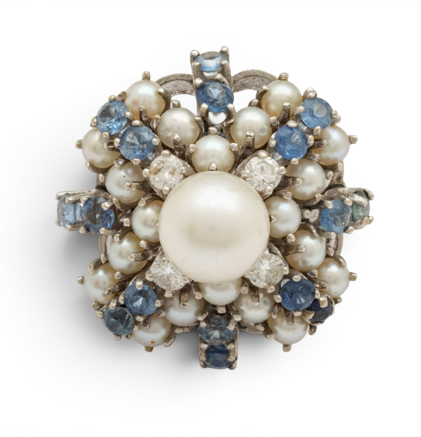 Diamond, Blue Sapphire, Pearl Cluster Ring 14K White Gold, Size 5 1950, 12 grams 1 PC: Diamond, Blue Sapphire, Pearl Cluster Ring 14K White Gold, Size 5 1950, 12 grams 1 PC 3mm pearl at center. Impressed 14K. Four prong set diamonds, 16 sapphires, 20 mini pearls. Provenance: Proper