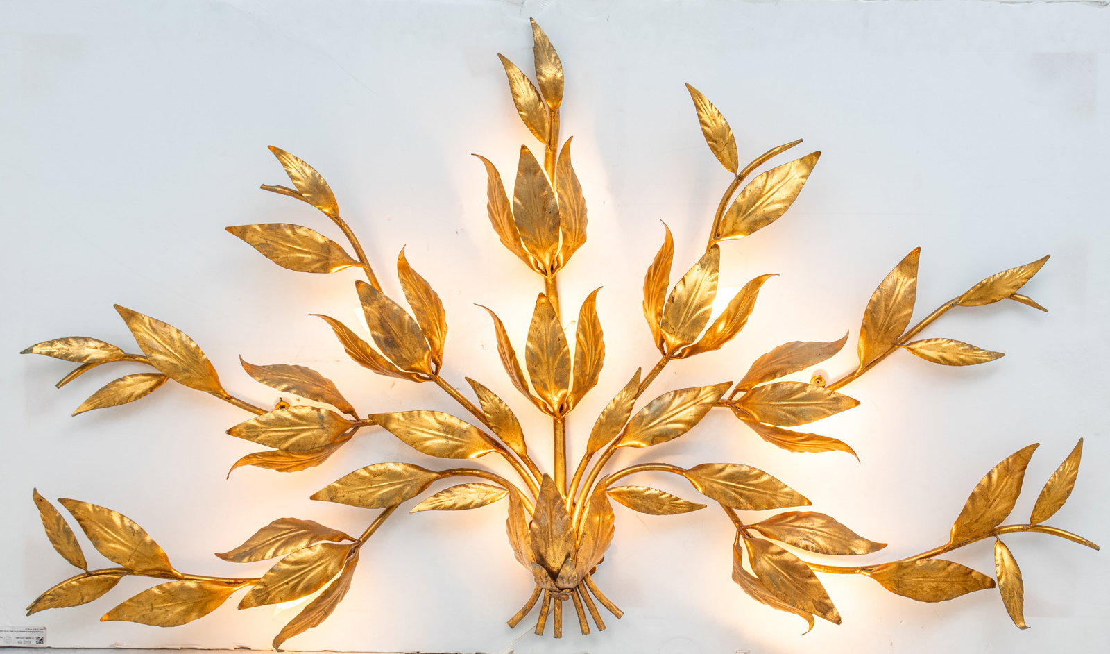 Attributed to Hans Kogl (German/Italian, 20th C.) Gilded White Metal Palm Leaf "Peacock" 9 Light: Attributed to Hans Kogl (German/Italian, 20th C.) Gilded White Metal Palm Leaf "Peacock" 9 Light Wall Sconce 1970, H 34" W 37" Nine light electrified wall sconce having palm leaves gathered at the cen