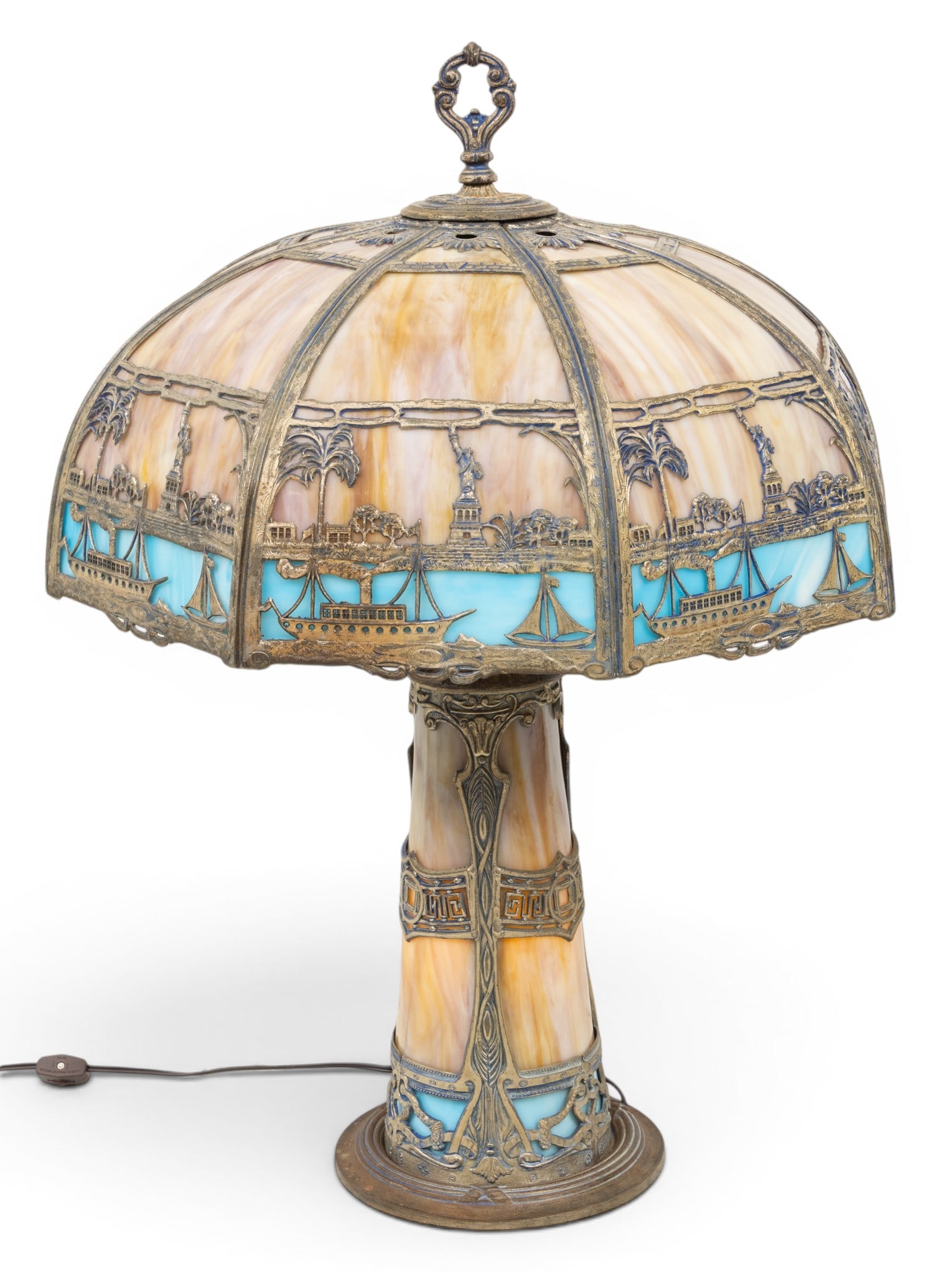 Slag Glass and Metal Statue of Liberty Table Lamp, Base Lights up 1920, H 28" Dia. 19" 1 PC: Slag Glass and Metal Statue of Liberty Table Lamp, Base Lights up 1920, H 28" Dia. 19" 1 PC Octagonal bent panels. Lowest metal band depicts sailing ships and Stature of Liberty. Dimensions: H 28" Dia