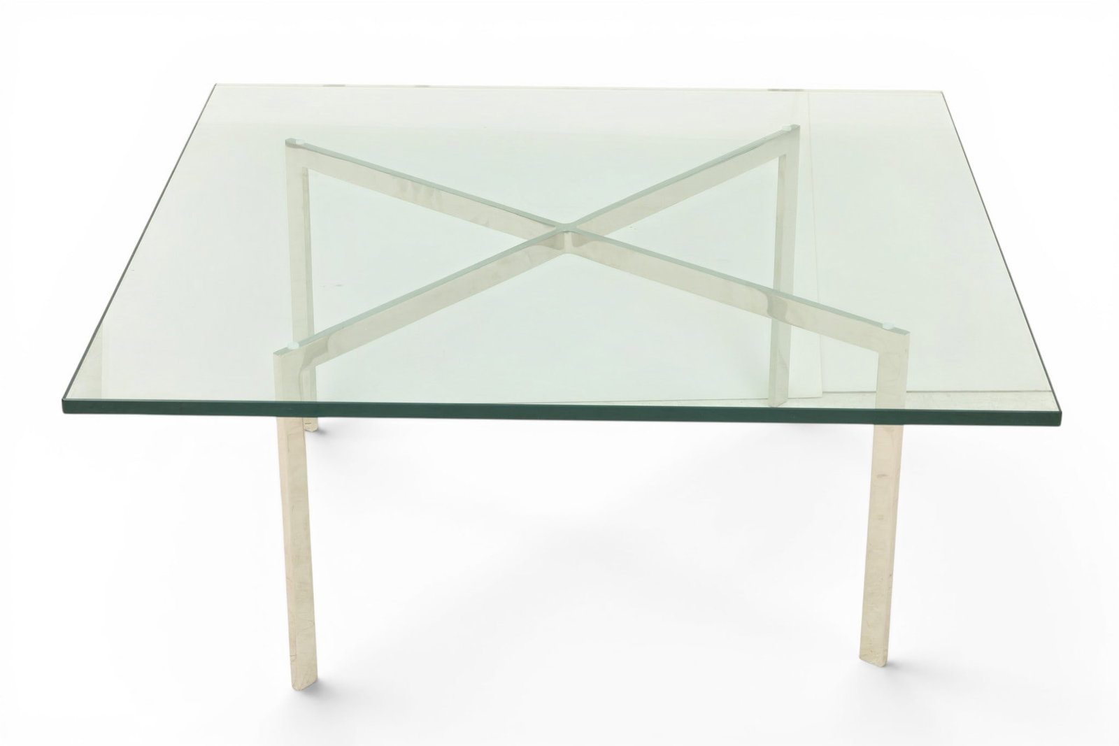 Knoll (American) Barcelona Glass and Chrome Coffee Table H 16.75" W 40" Depth 40": Knoll (American) Barcelona Glass and Chrome Coffee Table H 16.75" W 40" Depth 40" Having a square glass top above a chrome x-form base. designed by Ludwig Mies van der Rohe for Knoll. The frame i