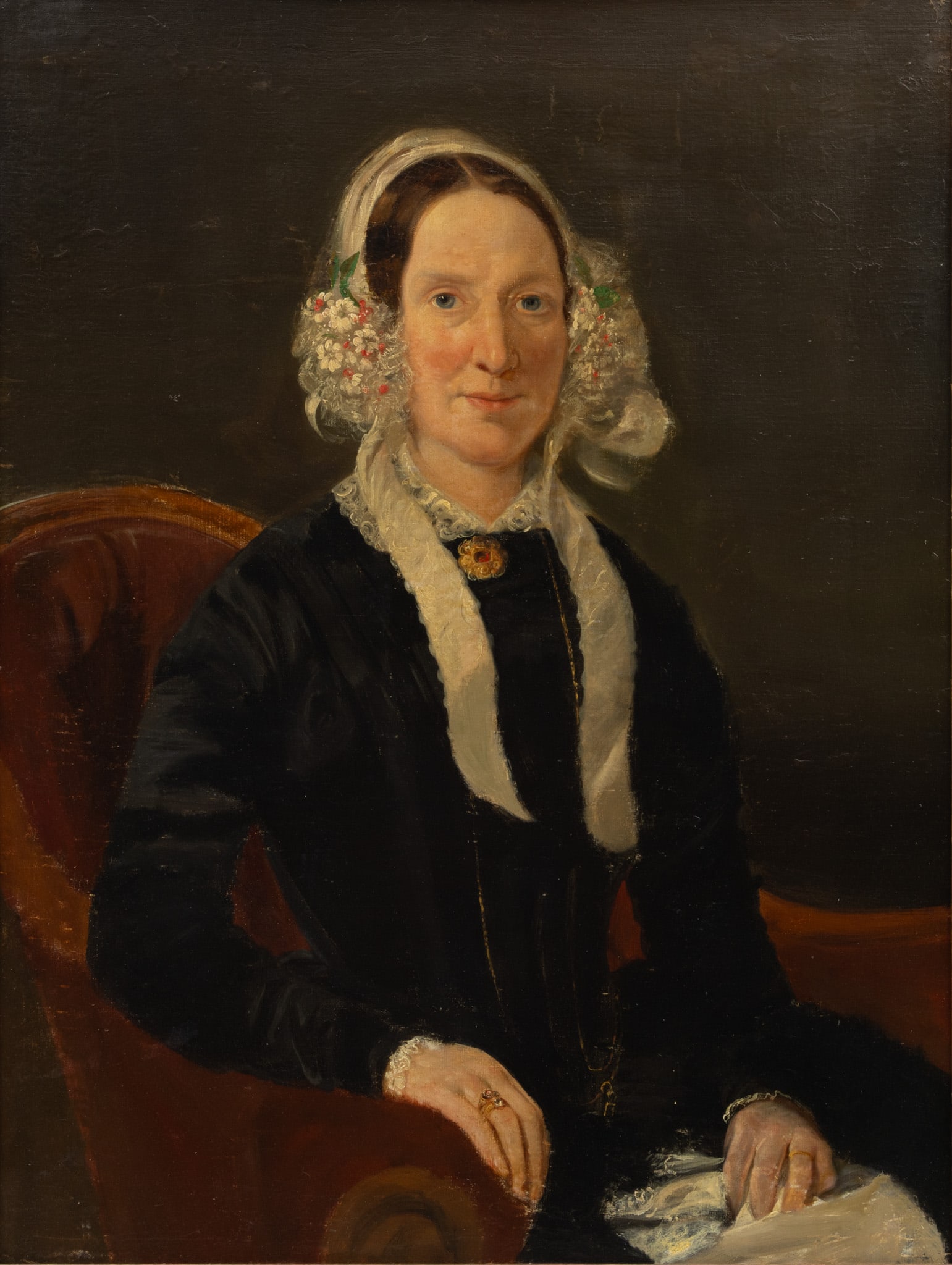 American Victorian Oil on Canvas 1860, 'Portrait of a Woman', H 25" W 27": American Victorian Oil on Canvas 1860, 'Portrait of a Woman', H 25" W 27" Depicting a seated woman wearing a gold and ruby brooch and floral adorned bonnet. Unsigned. Provenance: Property from t