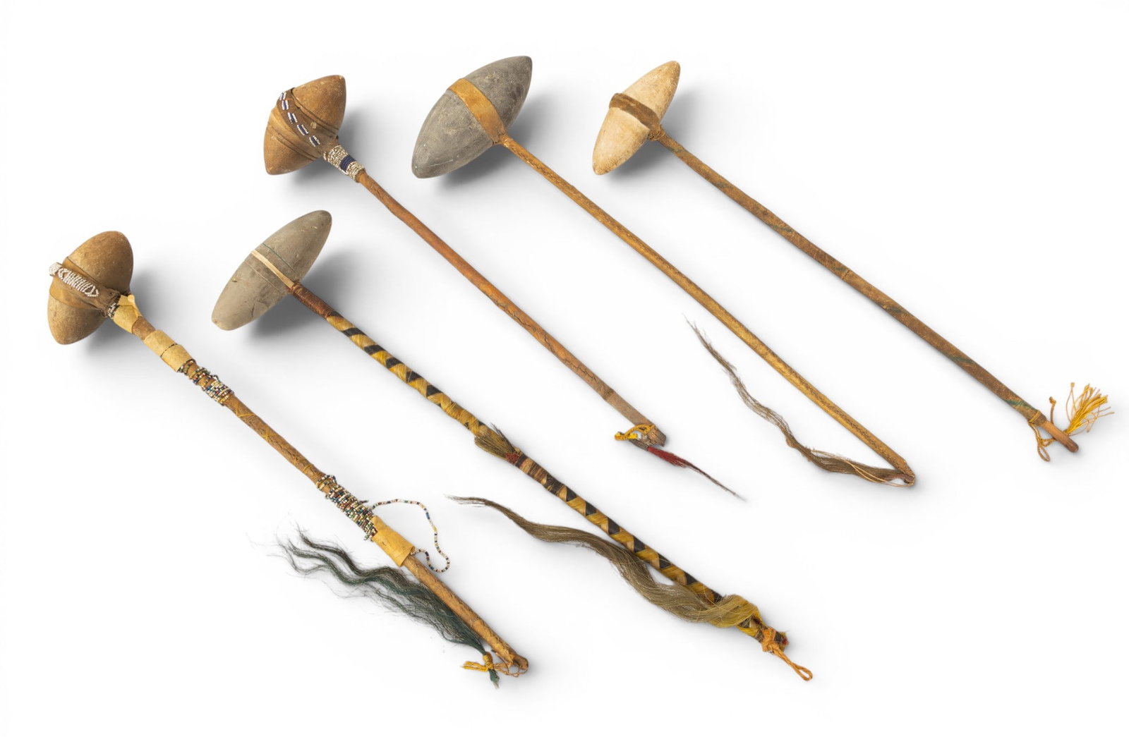 Native American, Plains Region, Ceremonial Stone and Wood War Clubs 5 PCS: Native American, Plains Region, Ceremonial Stone and Wood War Clubs 5 PCS Wood and leather handles with stone heads. Three with horse hair fringe. Length range 18"-21.5". Dimensions: 5 PCS