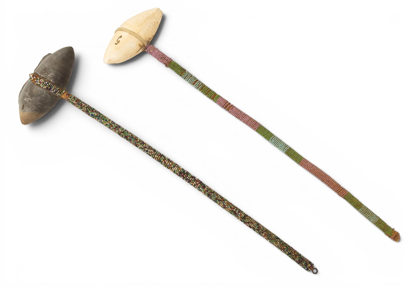 Native American, Plains Region, Stone, Wood, and Beadwork Ceremonial War Clubs 2 PCS: Native American, Plains Region, Stone, Wood, and Beadwork Ceremonial War Clubs 2 PCS One quartz head and one stone. Beaded wood handles. Dimensions: W 5.5" L 19.5" 1 PC W 5" L 20" 1 PC