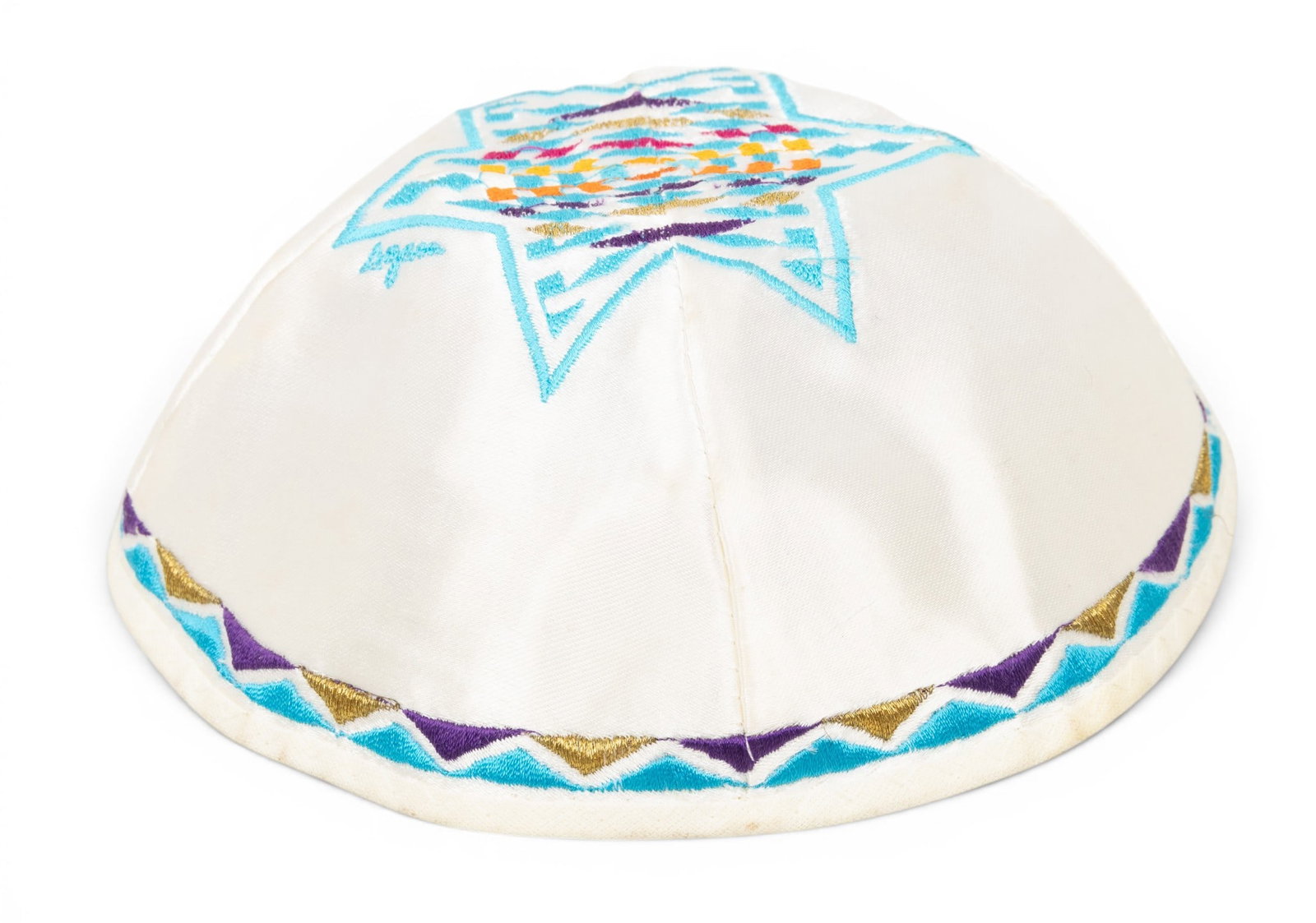 Yaacov Agam (Israeli, B. 1928) Embroidered Silk Yarmulke H 2" Dia. 6.75": Yaacov Agam (Israeli, B. 1928) Embroidered Silk Yarmulke H 2" Dia. 6.75" A silk embroidered Yarmulke signed in thread by Agam. Numbered 184/500 with Agam Kippa attached tags and COA label to the inter