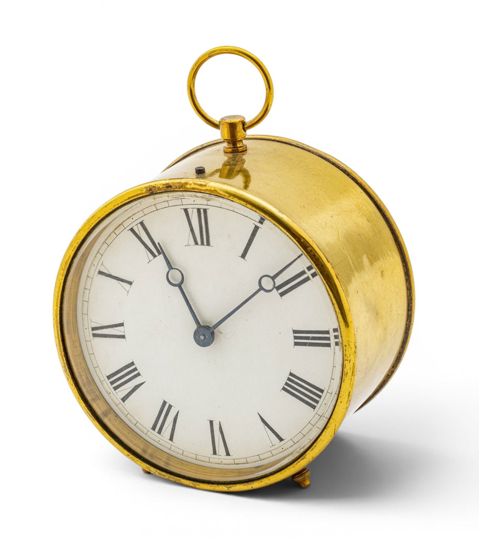 Brass Desk Clock, Ca. 19th C., H 4" Dia. 3.75": Brass Desk Clock, Ca. 19th C., H 4" Dia. 3.75" Of circular drum form with circular ring handle. White enameled dial with black roman numerals behind beveled glass. Raised on two front feet. Prov
