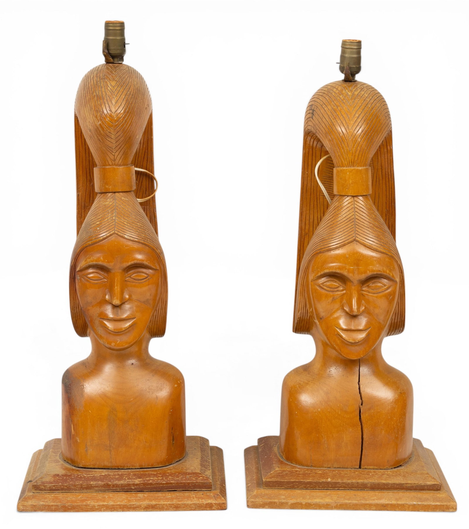 Hollywood Regency Pair of Carved Wood Table Lamps 20th Cent., H 28.5" W 12.25" Depth 10" 1 PAIR: Carved wood Polynesian influenced head formed table lamps. Needs to be rewired.