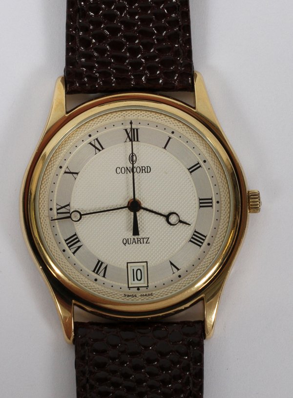 CONCORD MAN'S WATCH, 14 K. YELLOW GOLD PLATED: CONCORD GENTLEMAN'S WRIST WATCH, 14 K. YELLOW GOLD PLATED, QUILTED STERLING SILVER, DIA 15/16" CASE:inscribed "Concord Quartz Swiss Made" on fine diamond pattern face; Roman numerals, date window at 6