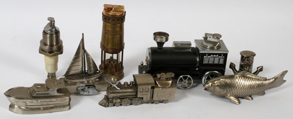 NAUTICAL TRAINS AUTOMOTIVE, CIGARETTE LIGHTERS: NAUTICAL, TRAINS AUTOMOTIVE THEME, ETC. CIGARETTE LIGHTERS, 8 PCS., H 3" - 6", L 3" - 6":includes: sailboat, cruiser, two steam locomotives, one spark plug, channel buoy, boat anchor and a fish.