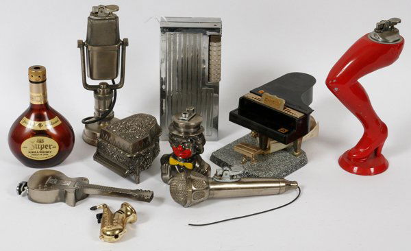 MUSICAL THEME MINIATURE METAL CIGARETTE LIGHTER: MUSICAL THEMED MINIATURE CAST METAL CIGARETTE LIGHTERS, MID 20TH C, H 1" - 6":includes two microphones, saxophone, guitar, two pianos, bust of a clown, miniature whisky bottle and a plated metal moder