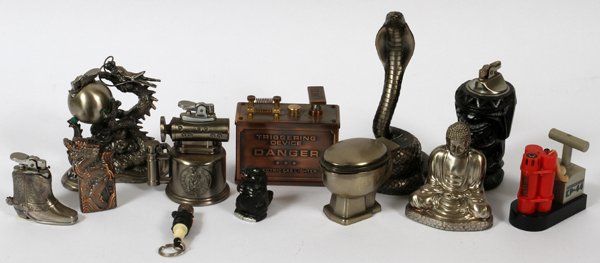 MINIATURE FIGURAL CAST METAL CIGARETTE LIGHTERS: MINIATURE FIGURAL CAST METAL CIGARETTE LIGHTERS, 12 PCS., H 2" - 6":includes a cobra snake, 'triggering device' gas lighter, two dragons, a cowboy boot, blow torch, spark plug, beaver, toilet bowl, Bu