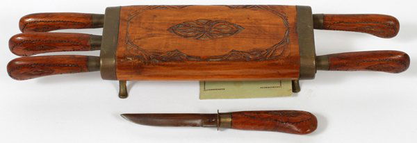 SAMURAI WOOD & BRASS CARVING SET; 6 KNIVES: SAMURAI WOOD & BRASS CARVING SET; 6 KNIVES:having a footed carved wood and brass case, six knives with carved wood handles and bands, stainless blades;