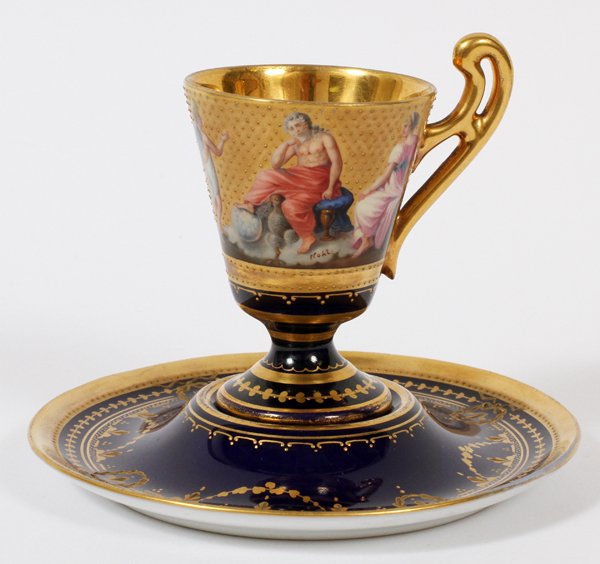 ROYAL VIENNA PORCELAIN DEMI TASSE & SAUCER: ROYAL VIENNA PORCELAIN DEMI TASSE & SAUCER, 'VENUS UND AMOR', SIGNED:Hand painted with Roman gods and goddesses, including Venus, Cupid, Mercury and Zeus, signed "Kohl", cobalt blue ground with fired 
