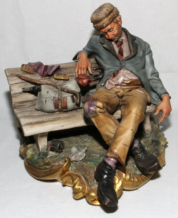 CAPO DI MONTE, ITALIAN BISQUE FIGURE, H 8": CAPO DI MONTE, ITALIAN BISQUE FIGURE, H 8", L 10":Man napping on park bench; marked "Made in Italy/443", signed on the reverse. Capo de Monte. From the Collection of John P. O'Hara, Bloomfield Hills, 