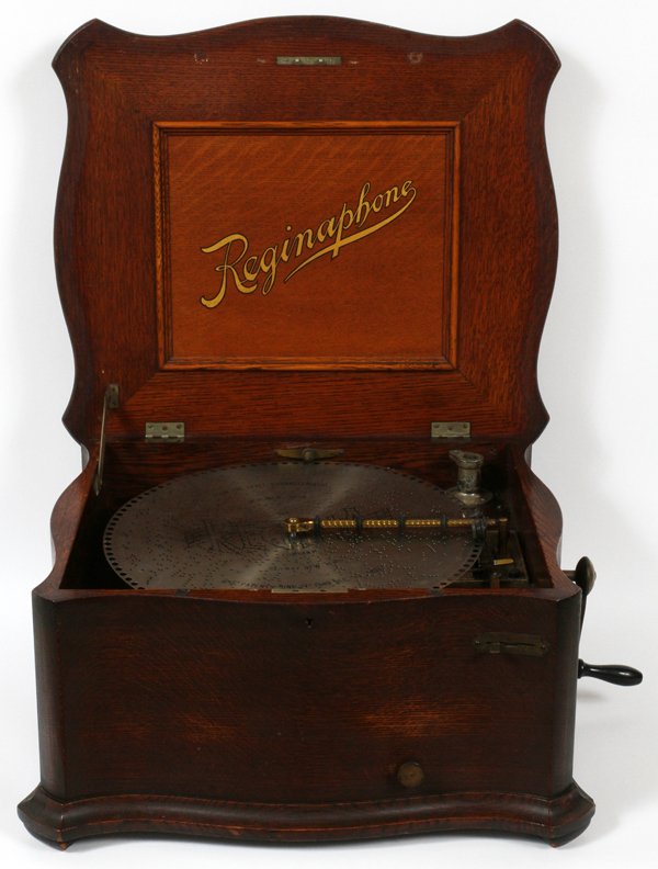 REGINAPHONE MODEL 150 MAHOGANY MUSIC BOX 1900 C: REGINAPHONE MODEL 150 MAHOGANY MUSIC BOX, CIRCA 1900, H 12", L 22", D 20":Manufactured by the Regina Company, Rahway, NJ. Double comb design and accompanied by thirty-eight discs. Sans cone.