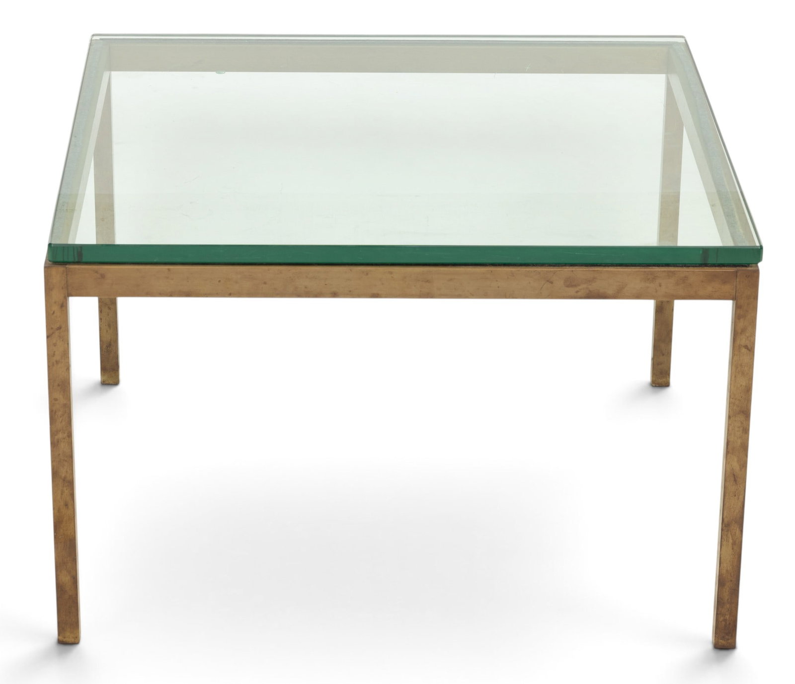 In the Manner of Milo Baughman (American, 1923-2003) Glass and Brass Table H 17" W 27" 1 PC: In the Manner of Milo Baughman (American, 1923-2003) Glass and Brass Table H 17" W 27" 1 PC Having a heavy brass base with straight legs under a glass top. Provenance: Property from a prominent 