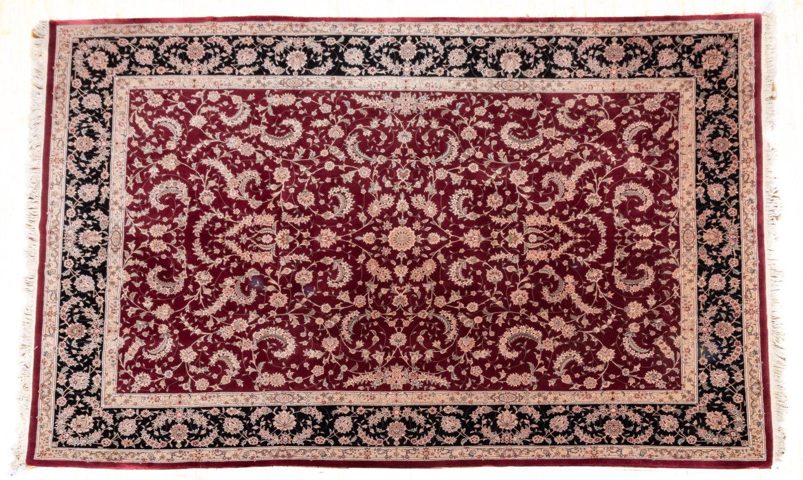 Sino-Tabriz Design Hand-woven Wool Rug, Ca. 1990s, W 10' 1" L 14' 1": Sino-Tabriz Design Hand-woven Wool Rug, Ca. 1990s, W 10' 1" L 14' 1" Wool pile with silk highlights. Burgundy ground with all over floral design. Outer border in black and beige. Provenance: A South L