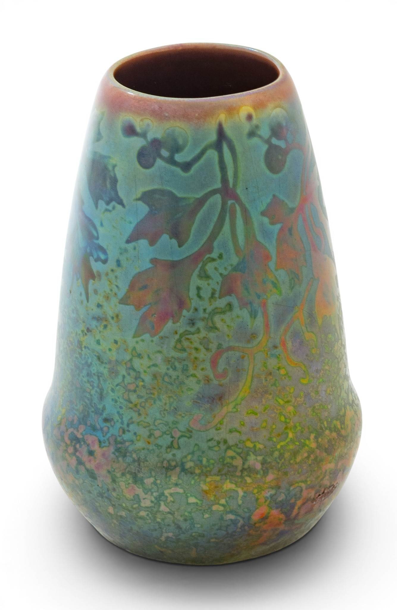Jacques Sicard for Weller Pottery (American) Art Nouveau Pottery Vase 1903-1907, 'Vase', H 5.25": Jacques Sicard for Weller Pottery (American) Art Nouveau Pottery Vase 1903-1907, 'Vase', H 5.25" Dia. 3.5" Having a leaf, berry, and foliate design in an iridescent purple and green metallic glaze. Un