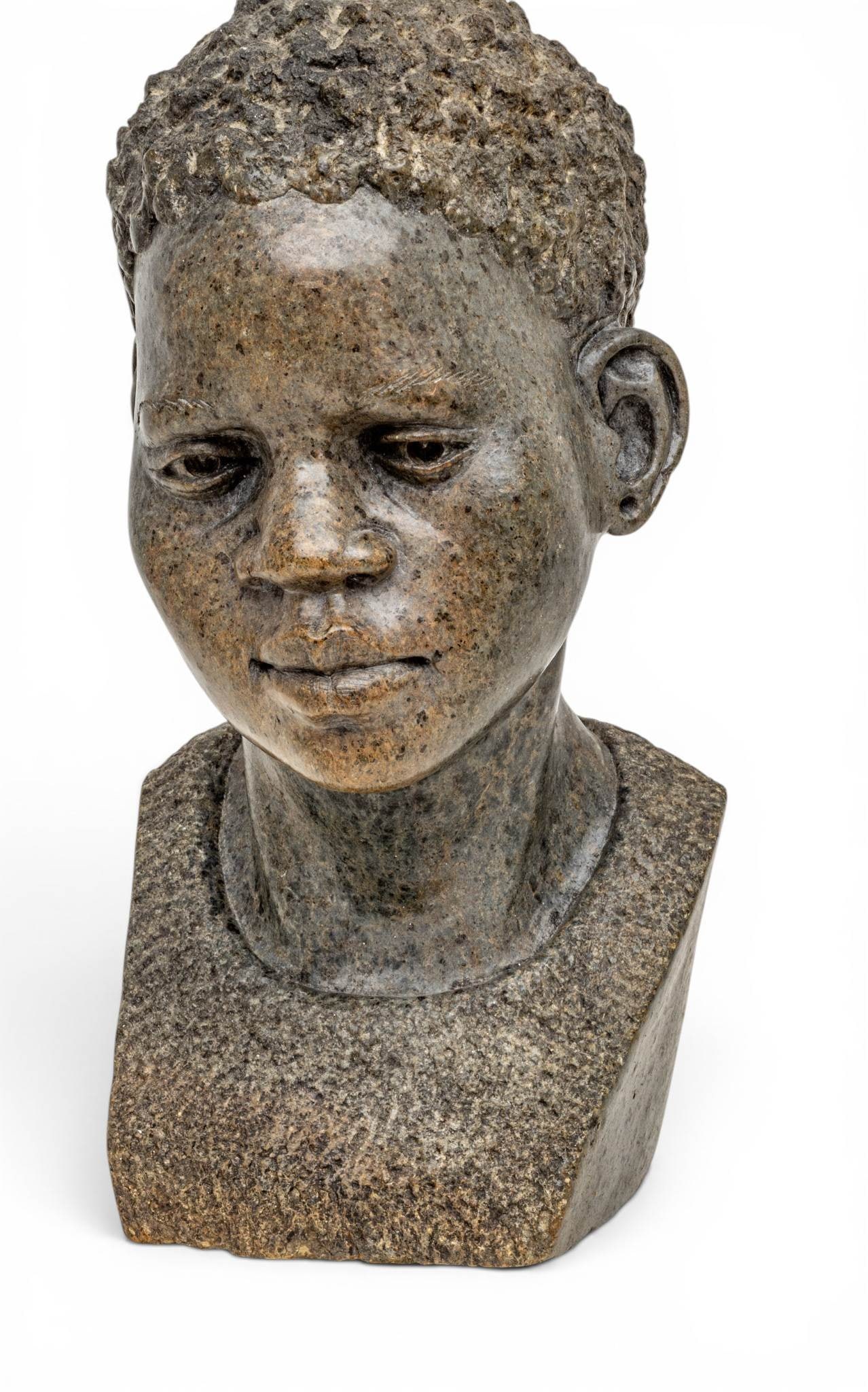 Zimbabwe Shona Carved Stone Sculpture Bust of a Young Man 20th Cent., H 12.5" W 7" Depth 8": Zimbabwe Shona Carved Stone Sculpture Bust of a Young Man 20th Cent., H 12.5" W 7" Depth 8" No signature apparent, fine carving. Provenance: Property from a Highland, MI private collector Dimensions: 