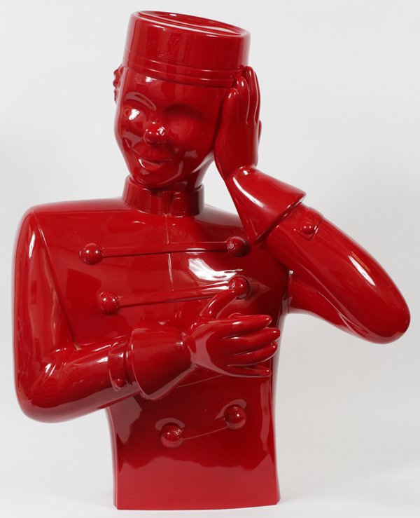 LOUIS VUITTON, 'BELLBOY' ADVERTISING FIXTURE, 34" X 26": LOUIS VUITTON 'BELLBOY' ADVERTISING FIXTURE, 34" X 26": Louis Vuitton advertising fixture, depicting a bellboy in red. "Louis Vuitton" on the buttons, "LV" logo on front of hat; "Made In France" on th