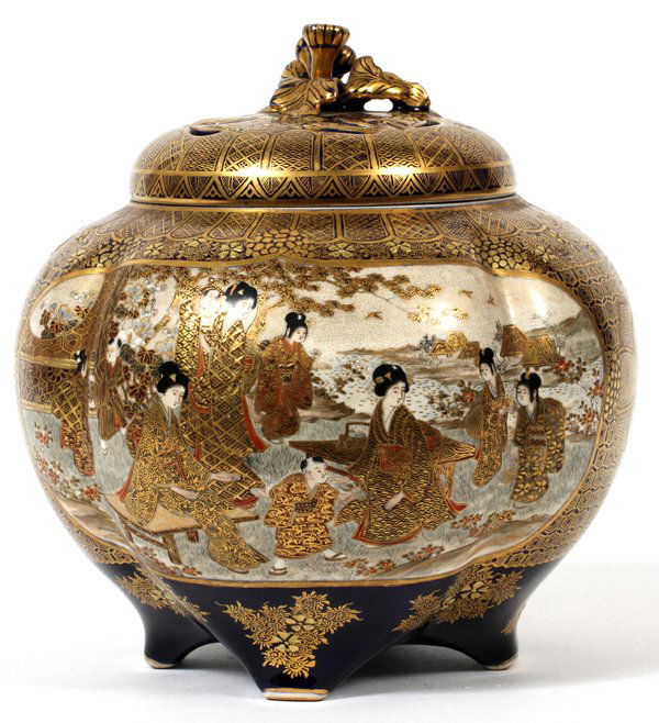 JAPANESE SATSUMA EARTHENWARE JAR, SIGNED, MEIJI: JAPANESE SATSUMA EARTHENWARE JAR, SIGNED, MEIJI PERIOD (1868-1912), H 7", DIA 7":having a flower and leaf motif lid with fired gold and blue enamel accents; palace scenes on sides, with male figures,