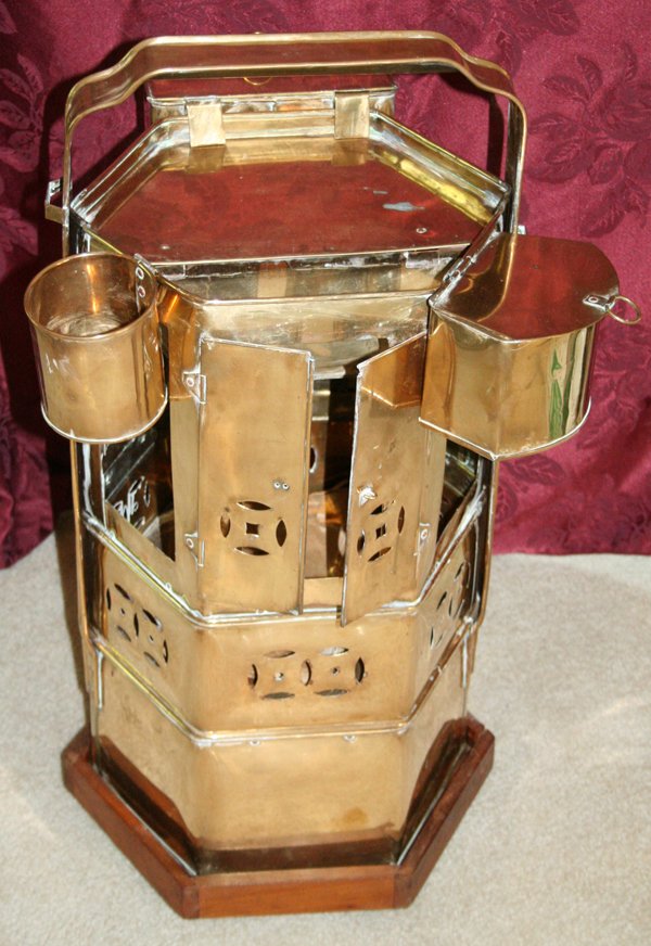 CHINESE BRASS NOODLE CART, H 28", W 18", D 19": CHINESE BRASS NOODLE CART, H 28", W 18", D 19":having a hexagonal body, with four glass panel inserts on the sides, with hinged doors opening to interior storage space, fixed brass strap style handle,