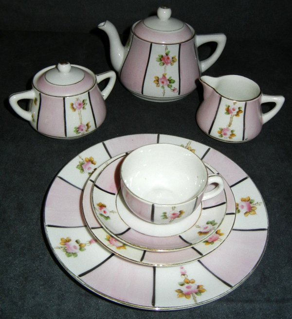 JAPANESE NORITAKE PORCELAIN CHILD'S TEA SET: JAPANESE NORITAKE PORCELAIN CHILD'S TEA SET:Includes 1 cookie plate, 6 1/2"; 4 cookie plates, 4 1/3"; 3 tea cups and 4 saucers; 1 tea pot; 1 creamer; 1 sugar. Also a miniature wicker couch and two cha