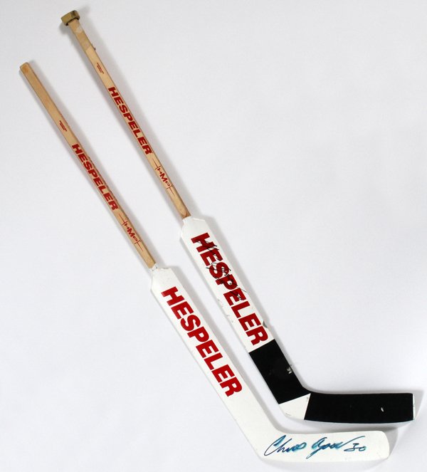 CHRIS OSGOOD AUTOGRAPHED GOALIE STICKS 2 PCS.: CHRIS OSGOOD AUTOGRAPHED GOALIE STICKS 2 PCS.:two Hespeler goalie sticks, one game used with black tape on the blade. Both autographed in black Sharpie. Game used stick signed up the handle above the 