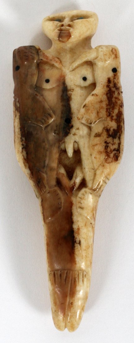 INUIT WALRUS CARVING WITH FACE & SEALS: INUIT WALRUS CARVING WITH FACE & SEALS, L 4 3/4":One piece. See front and back view. Estate of Christopher Seitz.