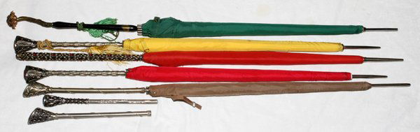 FILIGREE HANDLE UMBRELLAS (5) & HANDLES: FILIGREE HANDLE UMBRELLAS (5) & HANDLES:Including 5 nylon umbrellas with filigree handles and 2 additional handles. Seven items total. From a stately Grosse Pointe, Mich. Home.