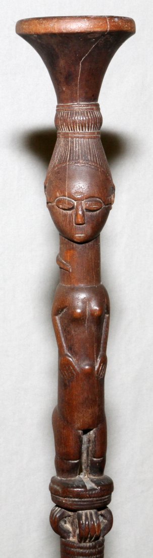 AFRICAN CARVED WOOD WALKING STICK METAL TIP 48"H: AFRICAN, CARVED WOOD, WALKING STICK WITH METAL TIP, H 48":Having female figural forms. Accompanied by a metal display stand.
