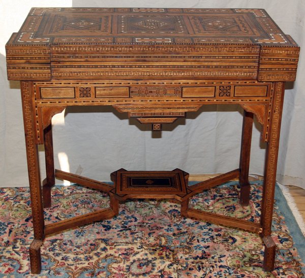 DAMASCUS FRUITWOOD INLAID FLIP TOP GAMES TABLE: DAMASCUS FRUITWOOD & MOTHER-OF-PEARL INLAID FLIP TOP GAMES TABLE, C. 1900, H 34", W 35" D 17":Top opens to card surface and further opens to chess/checkers board and backgammon board - includes game p