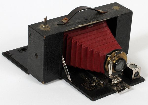 EASTMAN KODAK COMPANY #3-A BROWNIE CAMERA MODEL: EASTMAN KODAK COMPANY, NO. 3-A, FOLDING BROWNIE CAMERA, "MODEL A" C1909, H 4", W 6":having red bellows, nickel plated, brass lens housing, c1909; hinged back panel for loading roll film.