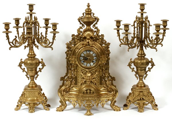 FRANZ HERMLE BRONZE CLOCK & CANDLELABRA: FRANZ HERMLE BRONZE CLOCK & CANDLELABRA H 24":THREE PIECE SET INCLUDES TWO CANDLELABRA WITH FIVE CANDLE HOLDERS EACH & MEASURES H 24" W 12" D 12". CLOCK MEASURES H 24" W 14" D 7" . MADE IN ITALY. DuMo