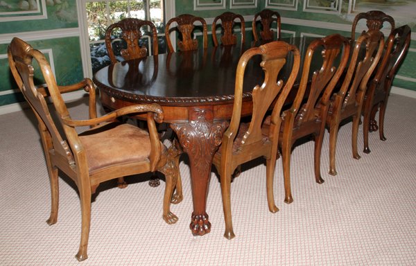 IRISH MAHOGANY OVAL DINING TABLE & SET OFCHAIRS: IRISH MAHOGANY OVAL DINING TABLE & SET OF (10) CHAIRS, WITH TWO LEAVES:The table (H 32", W ca. 45", L 60" closed, L ca. 103" extended with leaves) has two wide leaves, each 23" wide, on heavily carved