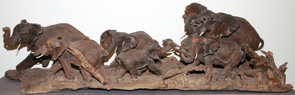 AFRICAN HAND CARVED HARDWOOD ELEPHANT PARADE: AFRICAN, HAND CARVED HARDWOOD, ELEPHANT PARADE, H 26", L 7' 10", D 26":depicting a herd of elephants. Having soapstone and bone tusks.