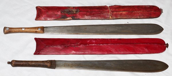TANZANIAN MASAI MACHETES TWO: TANZANIAN MASAI MACHETES TWO:Having blades L 15" and hide sheaths.